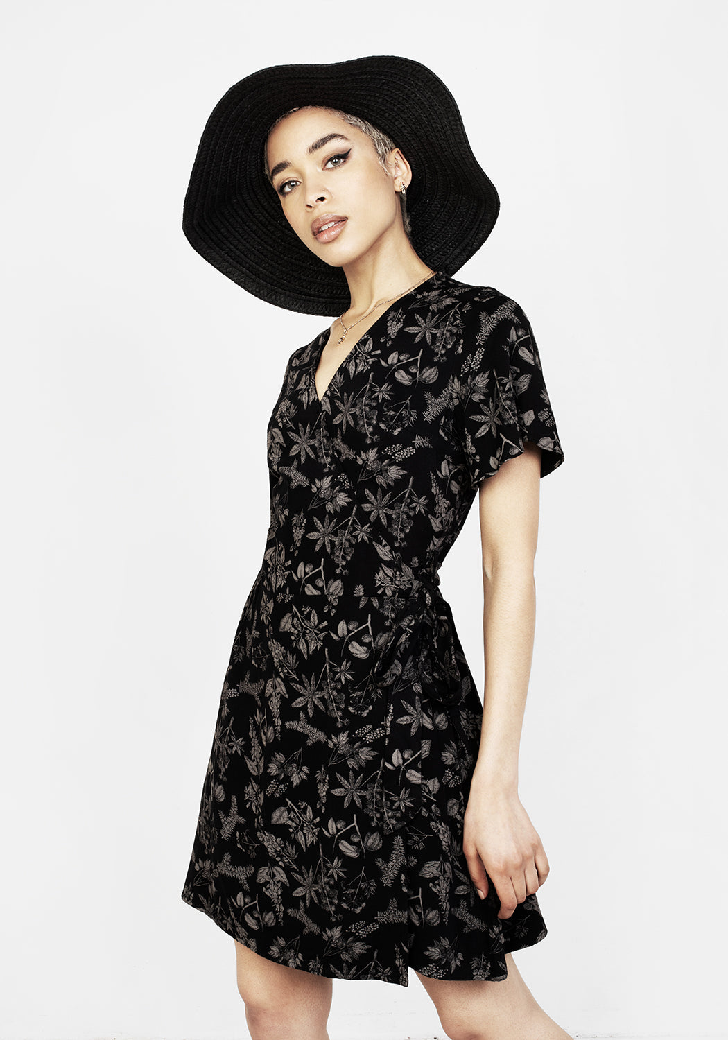 Black Wrap Mini Dress with Poisonous Plant Print | Short Sleeve & Non-Stretch