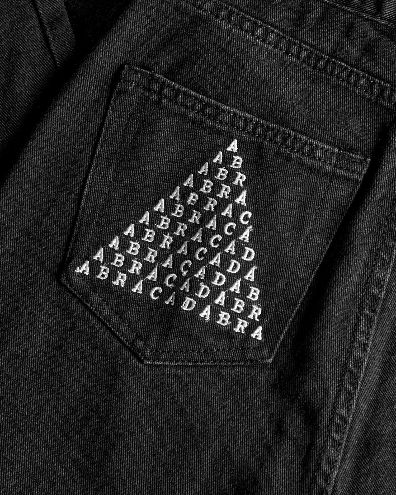 Distressed Black Denim Mom Jeans with Abracadabra Embroidery | Busted Knee Jean